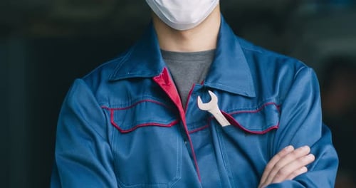 Car Mechanic Posing in Protective Medical Mask, Standing at Repair Workshop