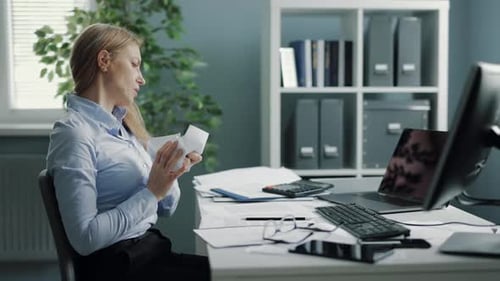 Stressed Woman Working at Office Desk