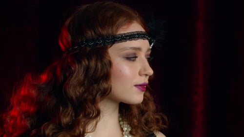 Portrait of Old-fashioned Red Haired Woman Dressed in Style of Great Gatsby Era Flirting and Posing