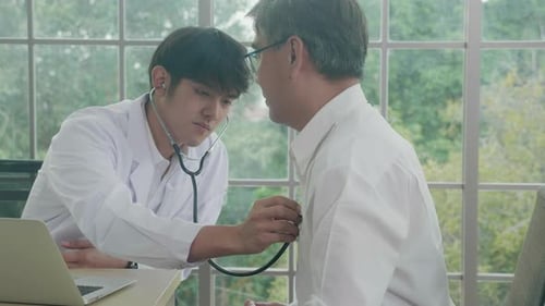 Young doctor examining pulse elderly about cardiology and diagnosis disease at clinic.