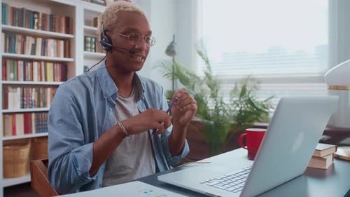 Young adult working at home using laptop