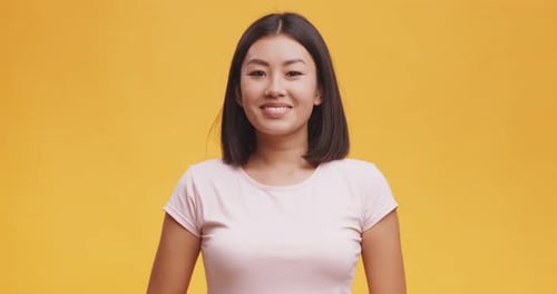 Smiling Woman Portrait on Yellow Background