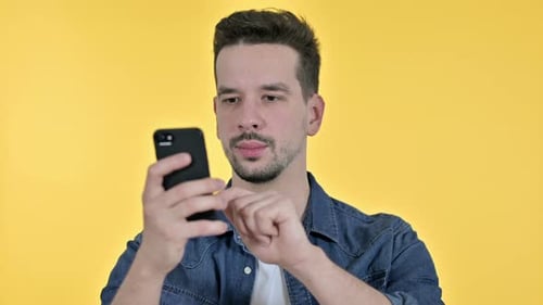 Young Adult Man Using a Smartphone