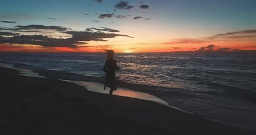 Girl Silhouette Running on Beach Ocean Sunset