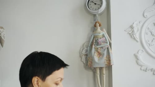Rag doll near a seamstress working