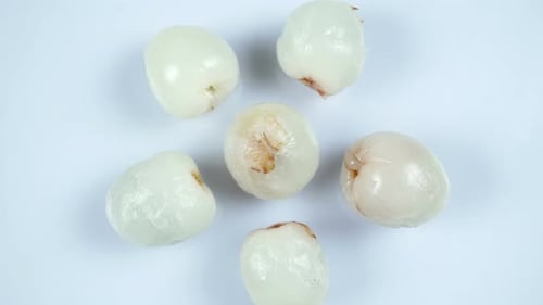 Peeled Lychees on a White Surface Close Up