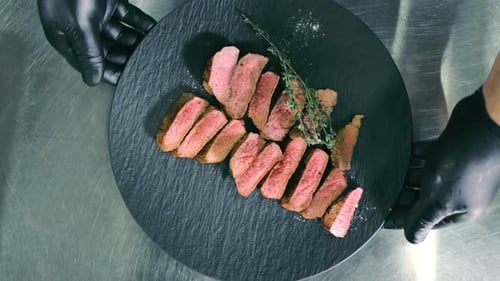 Juicy Steak Slices Served on Black Slate Plate