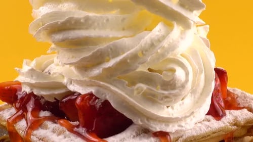 Delicious Waffles Topped with Strawberries and Whipped Cream