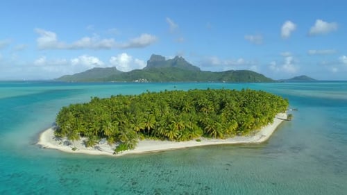 Aerial drone view of a deserted island near Bora Bora tropical island.