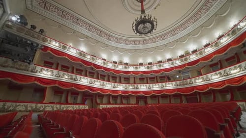 Large theatre hall with nobody. Rows of comfortable armchairs without people