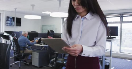 Woman using digital tablet at office