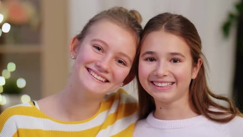 Smiling Young Girls Posing Close Together Indoors