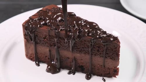 Chocolate Cake with Chocolate Syrup Being Drizzled