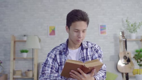 Young Adult Reading a Book Indoors