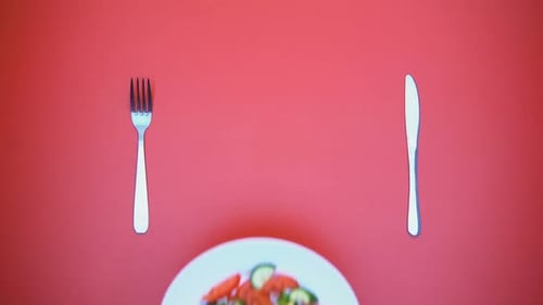 Salad on White Plate with Silverware Overhead Shot