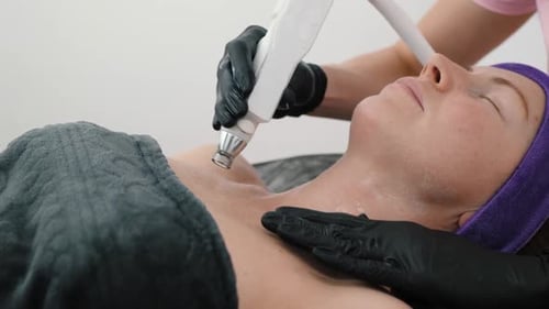 Woman receiving skin treatment on neck and chest