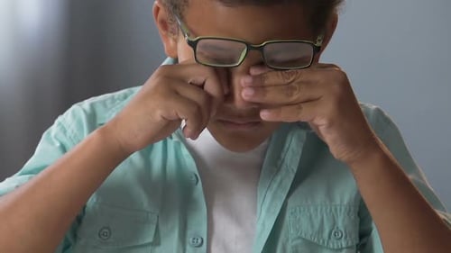 Child Rubbing Eyes Due to Discomfort