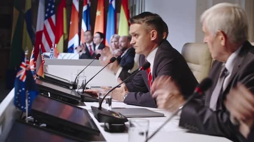 Political Conference with Speakers and International Flags
