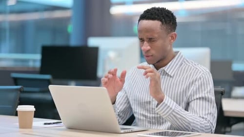 Man Working on Laptop Gets Headache in Office