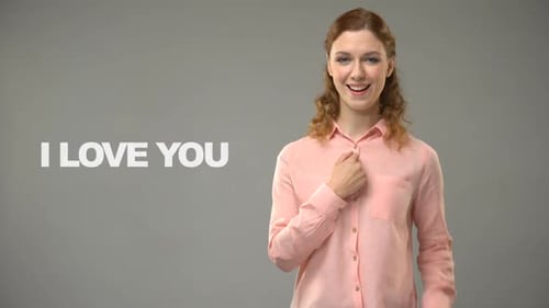 Woman Using Sign Language on Grey Background
