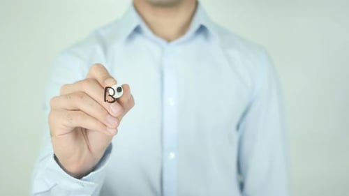 Man Writing Best Wishes on Clear Surface