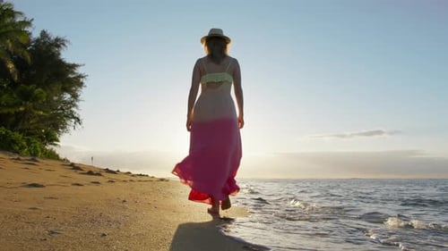 Back View Young Lady in Dress Waiving on Ocean Breeze Walking By Ocean Beach