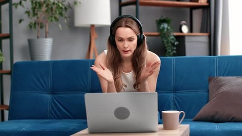 Woman Attends Meeting Over Laptop at Home