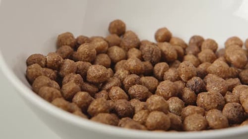 Cereal Pieces Dropping Into Bowl