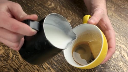 Pouring Milk Into Espresso For Coffee