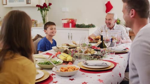 Family Celebrates Christmas Dinner Together at Home