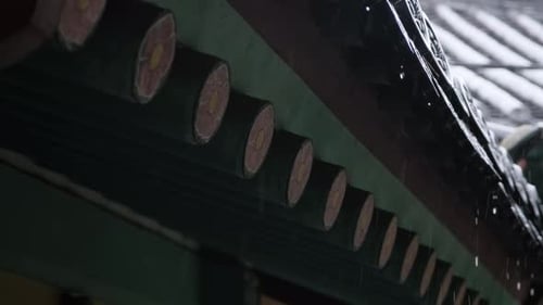 A close-up of traditional Korean houses on a rainy day.