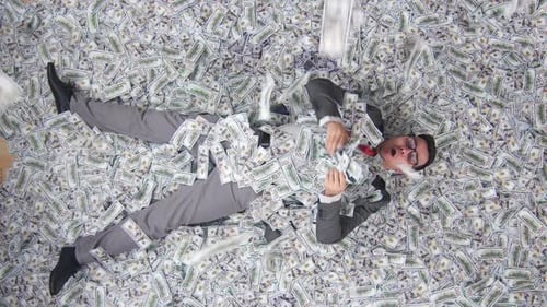 Joyful Businessman in Lies on the Background of Banknotes
