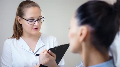 Doctor Talking to Patient While Taking Notes