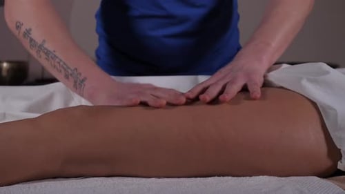 Massage Therapist Working on Person's Leg