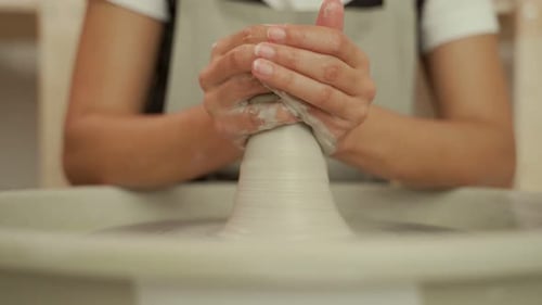 Hands Shape Clay on Pottery Wheel