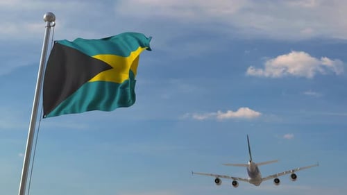 Bahamas National Flag Waving in Sky with Passing Airplane