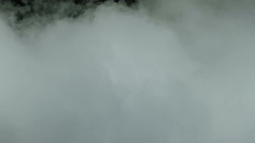 Drifting White Smoke Against a Dark Backdrop