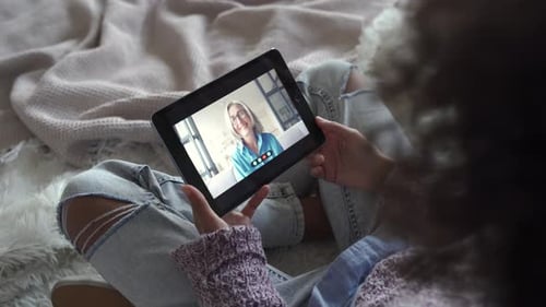 Girl Having Video Call on Tablet with Older Woman
