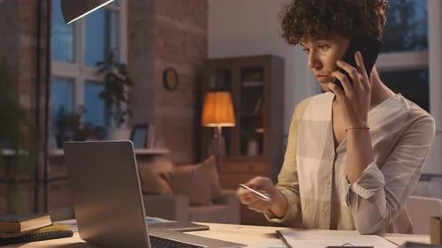 Woman on Cellphone Works At Home At Night