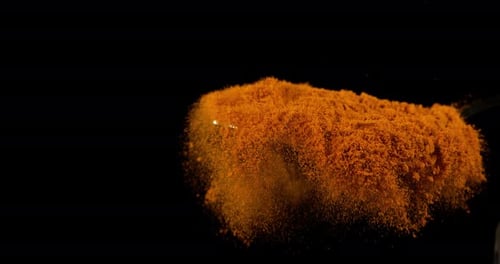 Turmeric, curcuma longa, Powder falling against Black Background, Indian Spice, Slow Motion 4K