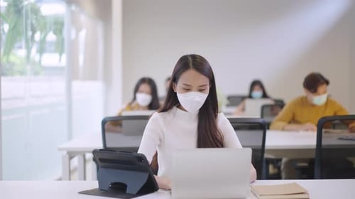 Office Workers Wearing Medical Face Masks at Desks