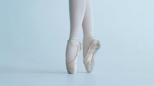Elegant Ballerina Performing En Pointe in Studio
