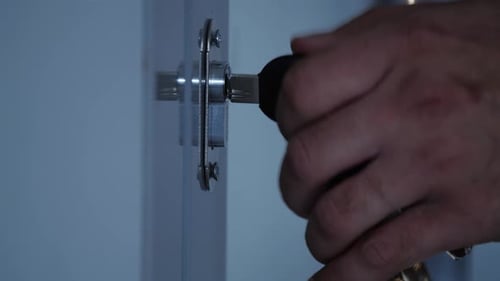Hand Unlocks Door with Key Close Up