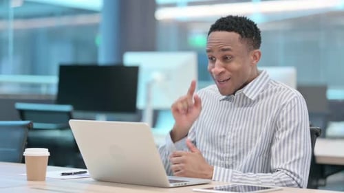 Young Adult Man on Video Conference in Office