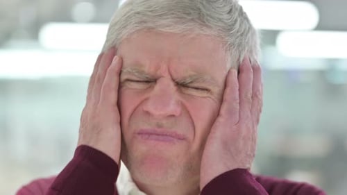 Close Up of Middle Aged Man with Headache