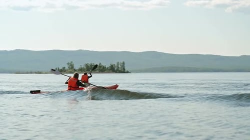 Kayaking Adventure on a Serene Lake During Daytime