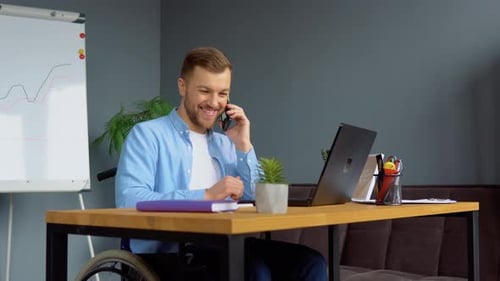 Office Worker in Wheelchair Talking on Phone