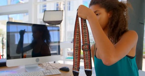 Model holding camera in photo studio