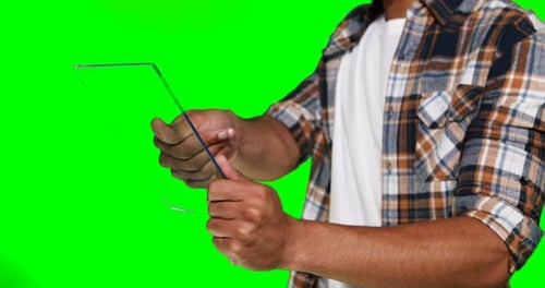 Man Using Transparent Tablet on Green Screen