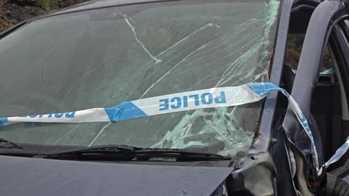 Car Wreckage with Police Tape in Rural Setting